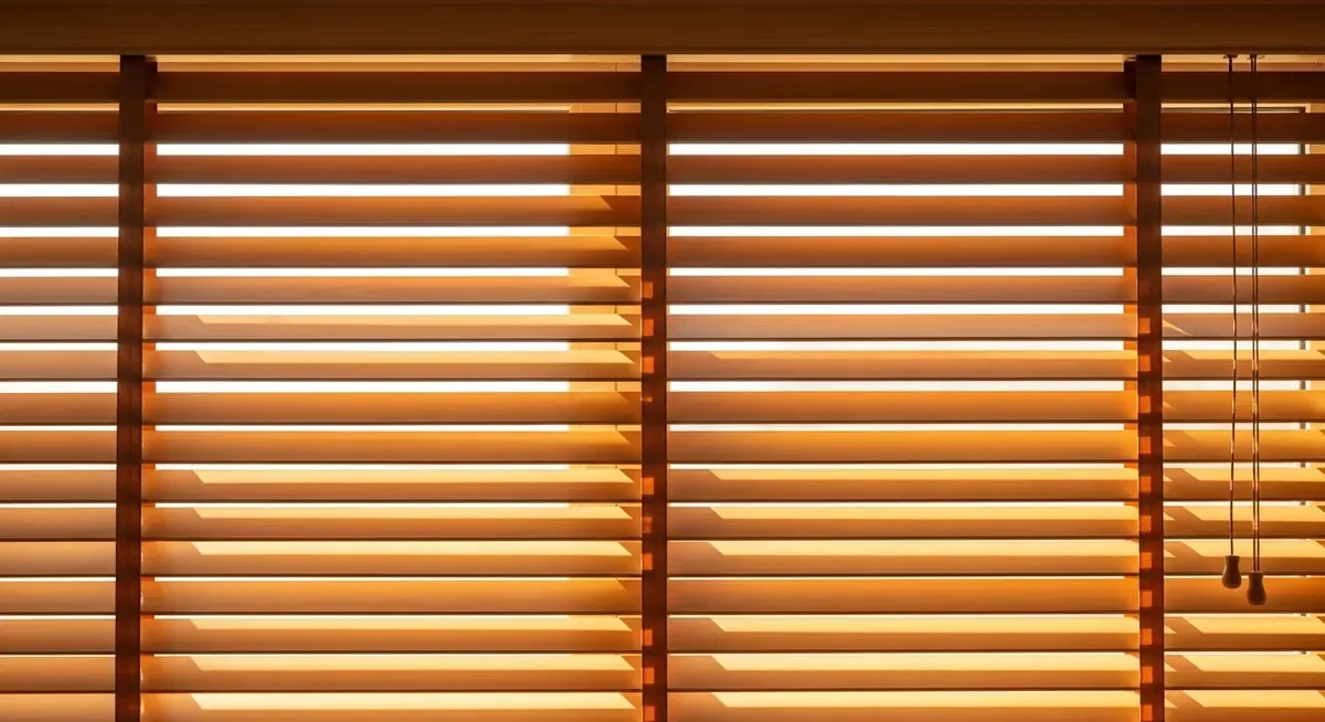 Close-up of warm faux wood blind slats with afternoon light