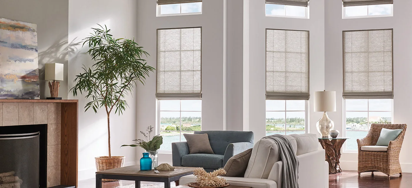 Woven wood Roman shades on tall living room windows in South Jordan