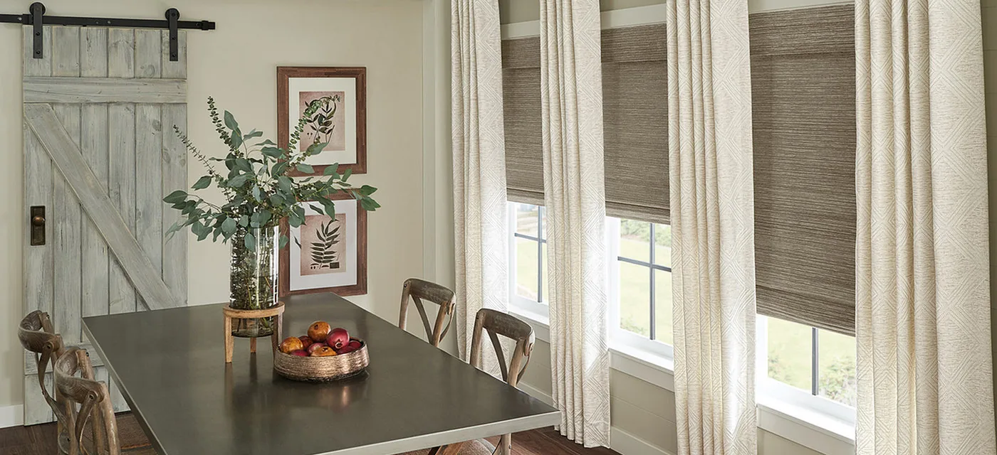 Woven wood shades and custom drapes in a South Jordan dining room